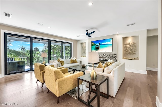 living room with ceiling fan and wood-type flooring