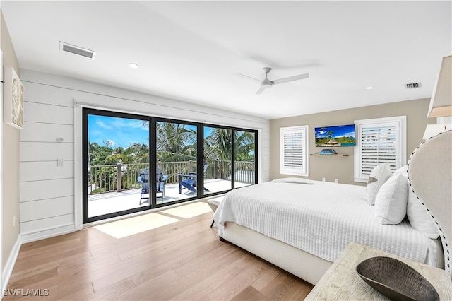 bedroom featuring access to exterior, ceiling fan, and light wood-type flooring