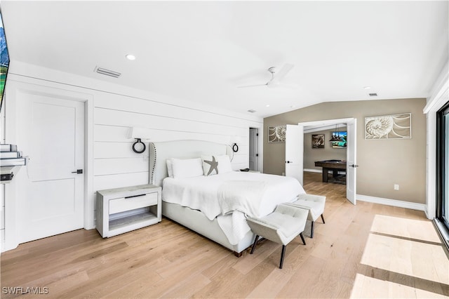 bedroom with ceiling fan, vaulted ceiling, and light hardwood / wood-style flooring