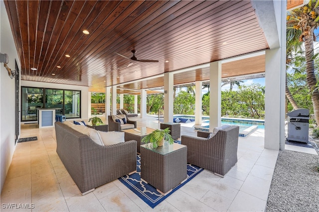 view of patio featuring an outdoor living space, ceiling fan, and a grill