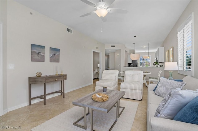 tiled living room featuring ceiling fan