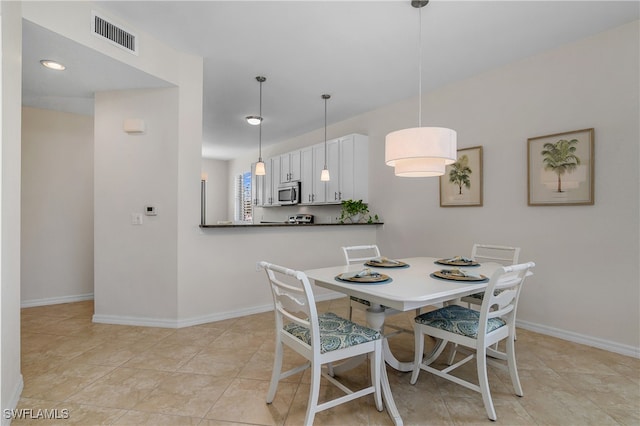 dining space featuring light tile patterned floors