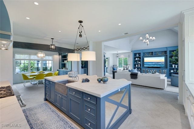 254 Audubon Blvd, Naples, FL 34110 - kitchen featuring a sink, white cabinetry, blue cabinetry, and a chandelier