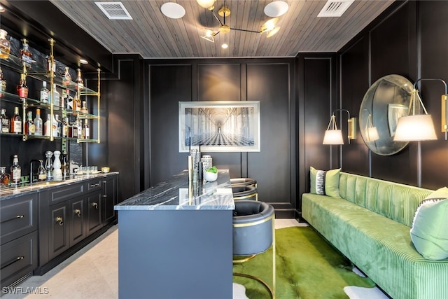 254 Audubon Blvd, Naples, FL 34110 - interior space featuring a decorative wall, indoor wet bar, visible vents, and wood ceiling