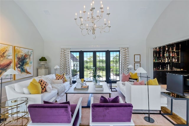 living room featuring lofted ceiling, french doors, and indoor bar