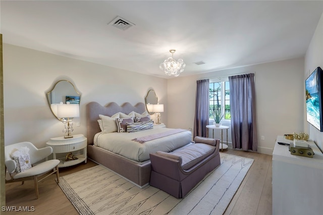 254 Audubon Blvd, Naples, FL 34110 - bedroom with a notable chandelier, visible vents, and light wood-style flooring