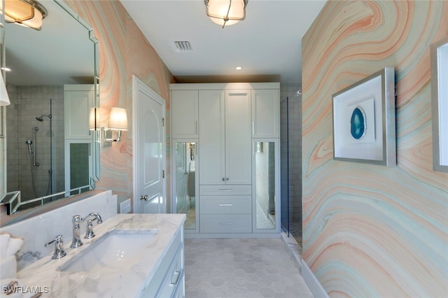 bathroom featuring walk in shower, tile patterned floors, and vanity