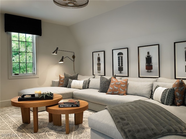 living room featuring lofted ceiling