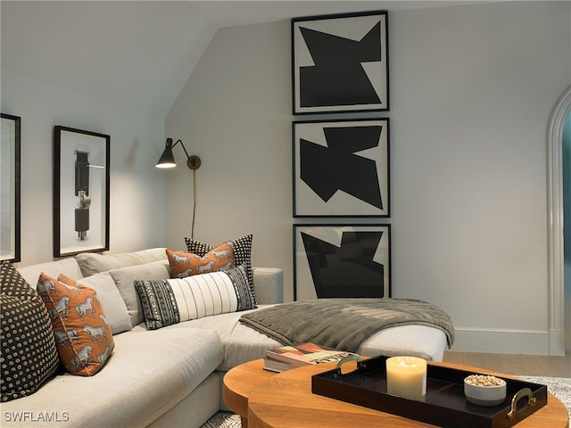 living room featuring lofted ceiling