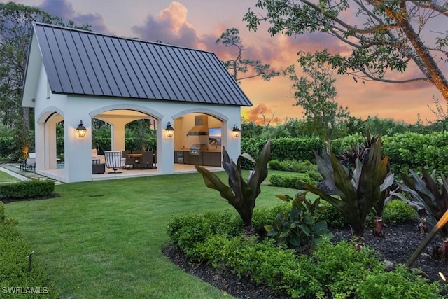 254 Audubon Blvd, Naples, FL 34110 - yard at dusk with a patio and area for grilling