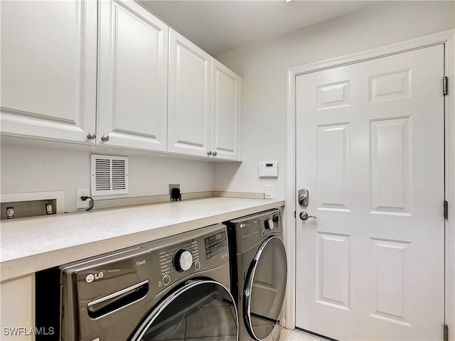 laundry area with cabinets and washer and dryer