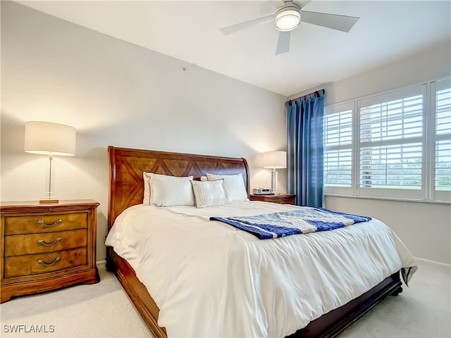 bedroom featuring light colored carpet and ceiling fan