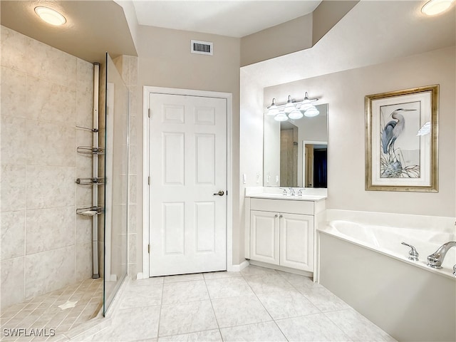 bathroom featuring vanity, independent shower and bath, and tile patterned floors