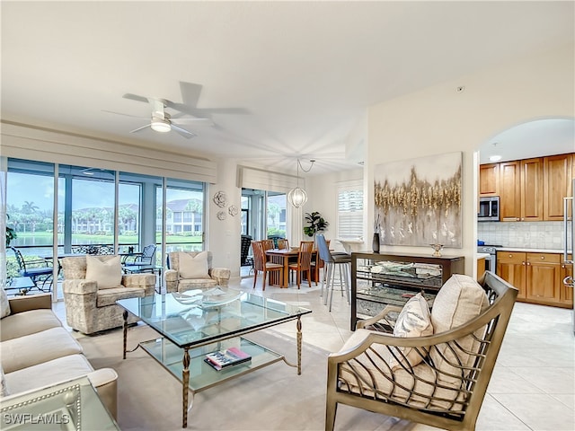 living room with ceiling fan and light tile patterned floors