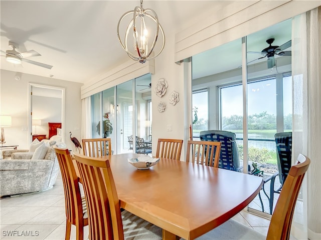 dining room featuring ceiling fan with notable chandelier and light tile patterned floors