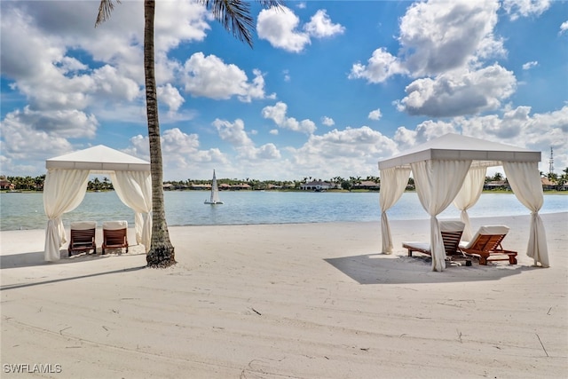 property view of water with a gazebo and a beach view