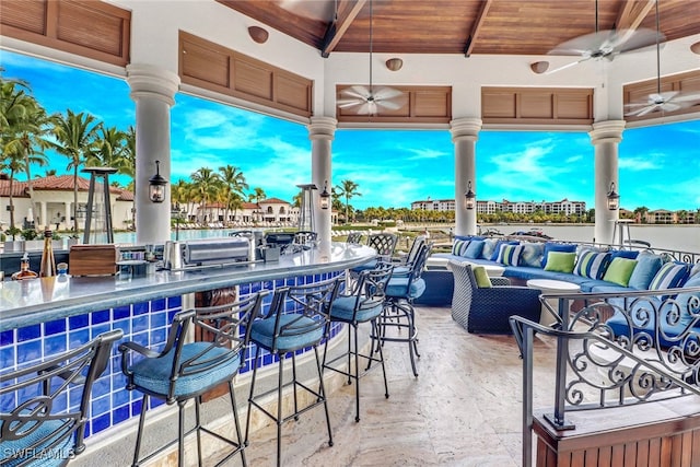 view of patio / terrace with ceiling fan, outdoor lounge area, and an outdoor bar