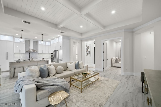 living room featuring light hardwood / wood-style flooring and beamed ceiling