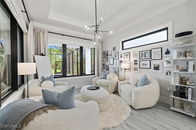 interior space with wooden ceiling, light hardwood / wood-style flooring, a tray ceiling, and an inviting chandelier