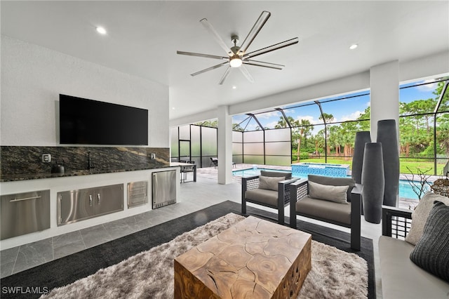 living room featuring ceiling fan and a wealth of natural light