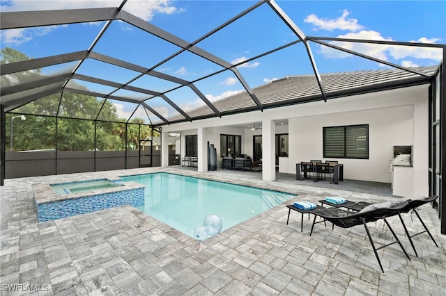 view of swimming pool with a lanai, ceiling fan, a patio area, and an in ground hot tub