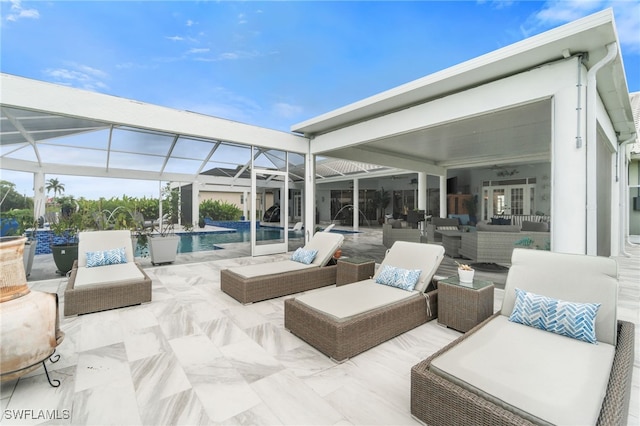 view of patio featuring glass enclosure and an outdoor hangout area