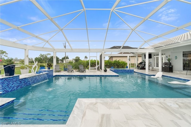 view of swimming pool with pool water feature, a patio, and glass enclosure