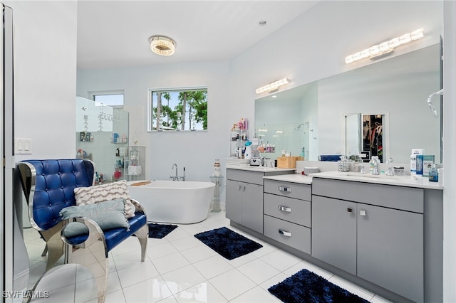 bathroom with tile patterned flooring, vanity, and shower with separate bathtub