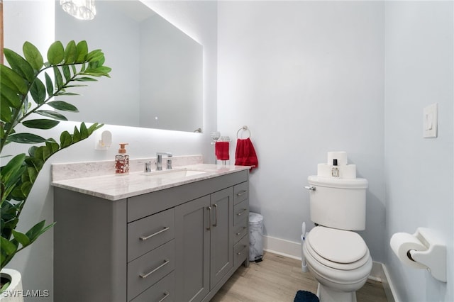 bathroom with vanity, hardwood / wood-style flooring, and toilet