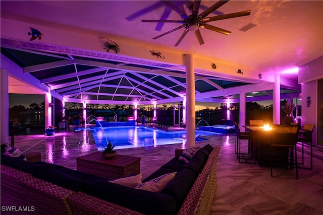 view of swimming pool with outdoor lounge area, a bar, and pool water feature