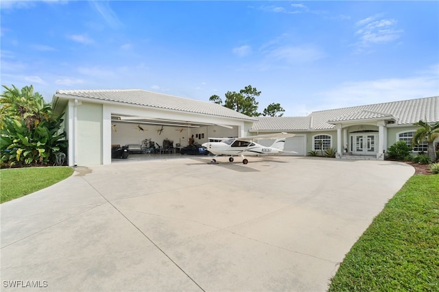 exterior space with a garage and french doors