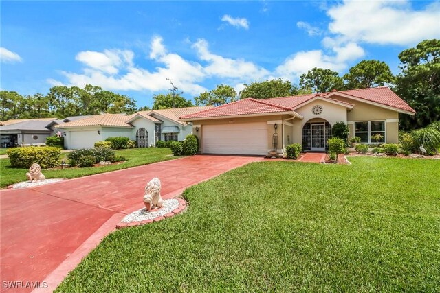 mediterranean / spanish-style home featuring a garage and a front lawn