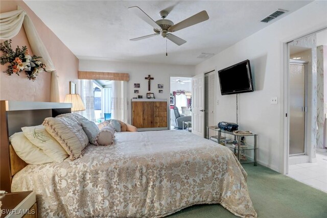 bedroom with a closet, ceiling fan, connected bathroom, and carpet