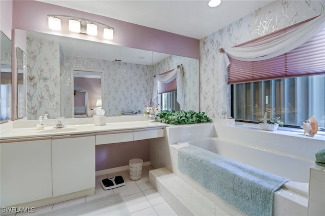 bathroom featuring tile patterned flooring, a relaxing tiled tub, and vanity