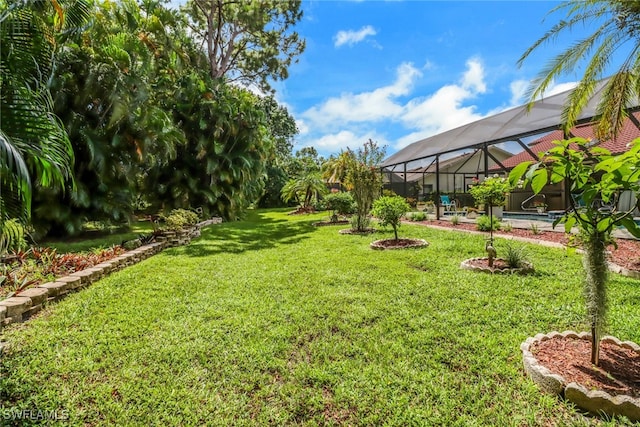 view of yard featuring glass enclosure