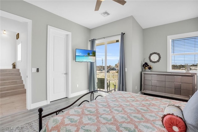 bedroom featuring a ceiling fan, baseboards, visible vents, access to exterior, and light wood finished floors