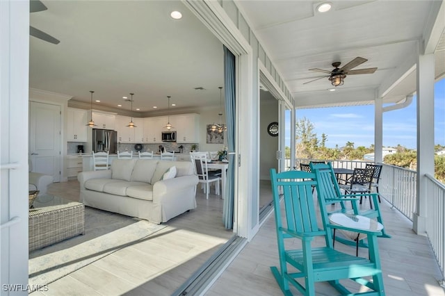 balcony with outdoor dining area, outdoor lounge area, and a ceiling fan