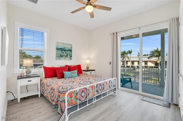 bedroom featuring ceiling fan, light hardwood / wood-style floors, and access to outside