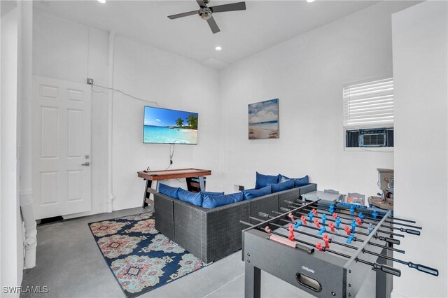 recreation room with ceiling fan, cooling unit, and concrete flooring