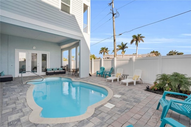 view of pool featuring a fenced in pool, a patio area, french doors, and a fenced backyard