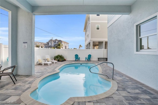 view of swimming pool featuring a fenced in pool, a fenced backyard, and a patio