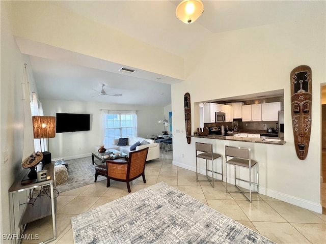 tiled living room featuring ceiling fan