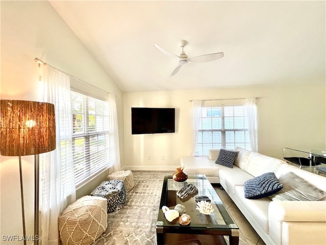 living room featuring lofted ceiling, ceiling fan, and a healthy amount of sunlight