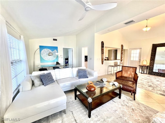 living room featuring lofted ceiling, tile patterned flooring, a wealth of natural light, and ceiling fan