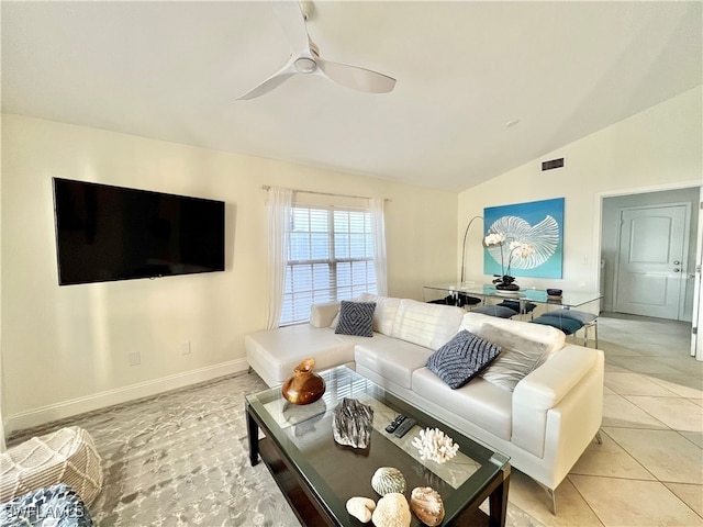 living room with lofted ceiling, light tile patterned flooring, and ceiling fan