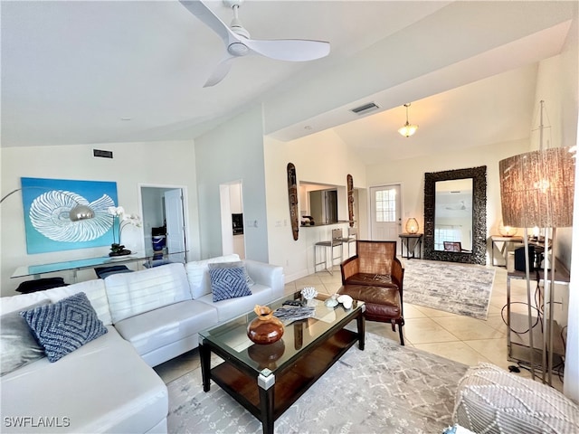 living room featuring vaulted ceiling, light tile patterned floors, and ceiling fan