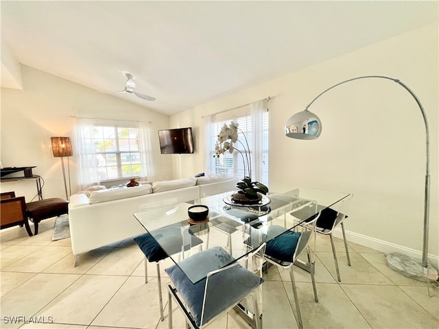 dining area featuring vaulted ceiling, light tile patterned flooring, and ceiling fan