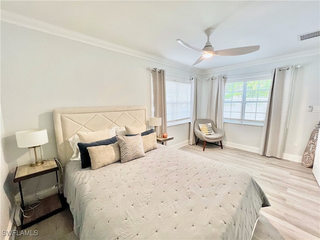 bedroom featuring light hardwood / wood-style flooring, ceiling fan, and ornamental molding