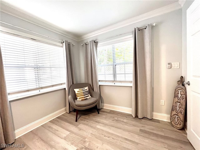 sitting room featuring ornamental molding and light hardwood / wood-style flooring