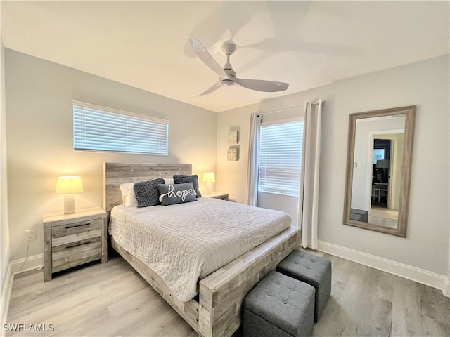 bedroom featuring multiple windows, ceiling fan, and light hardwood / wood-style floors